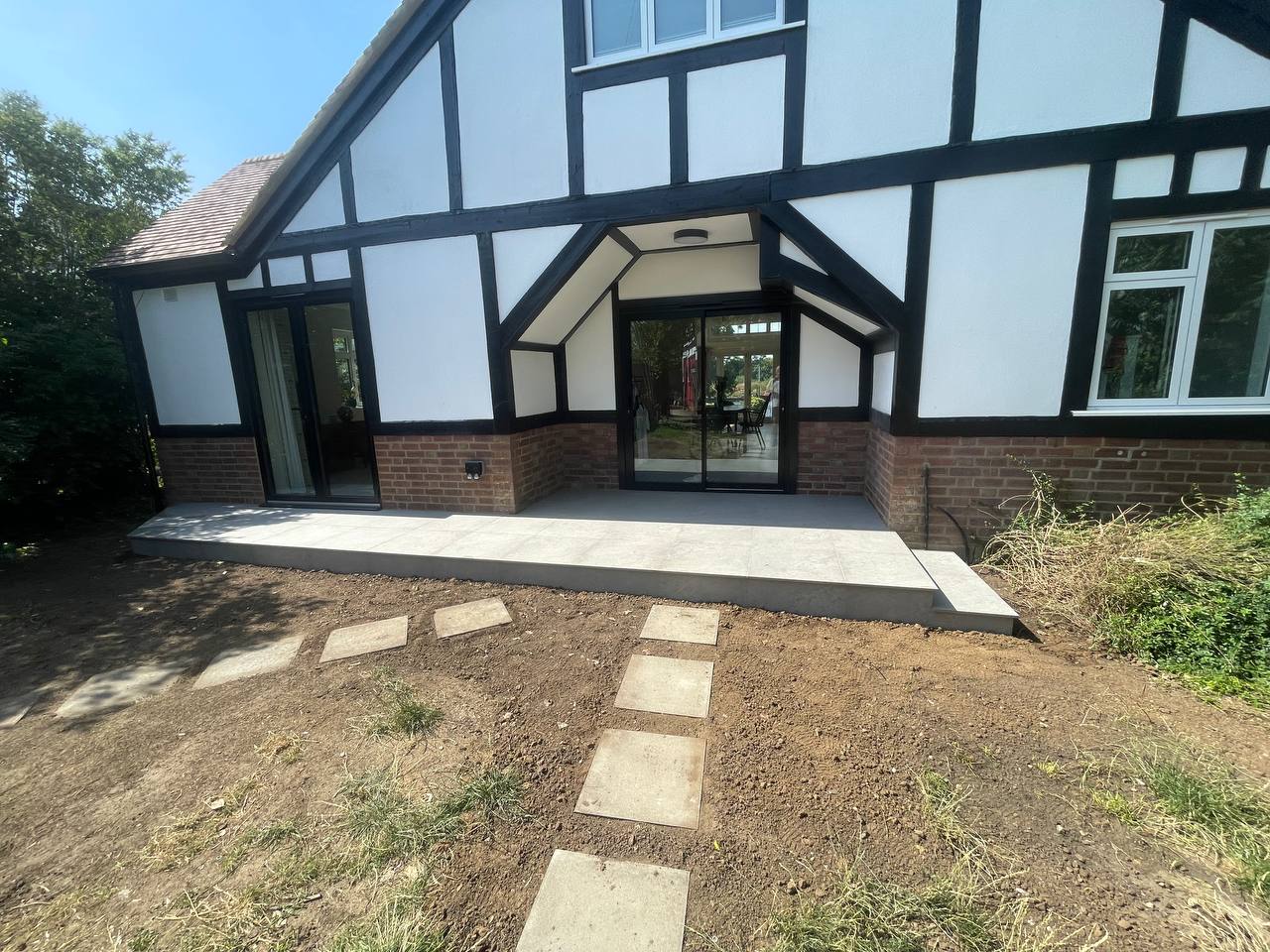 After — rear elevation sliding doors and new paving