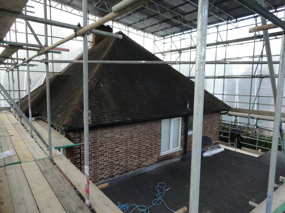 During — old roof exposed inside scaffold