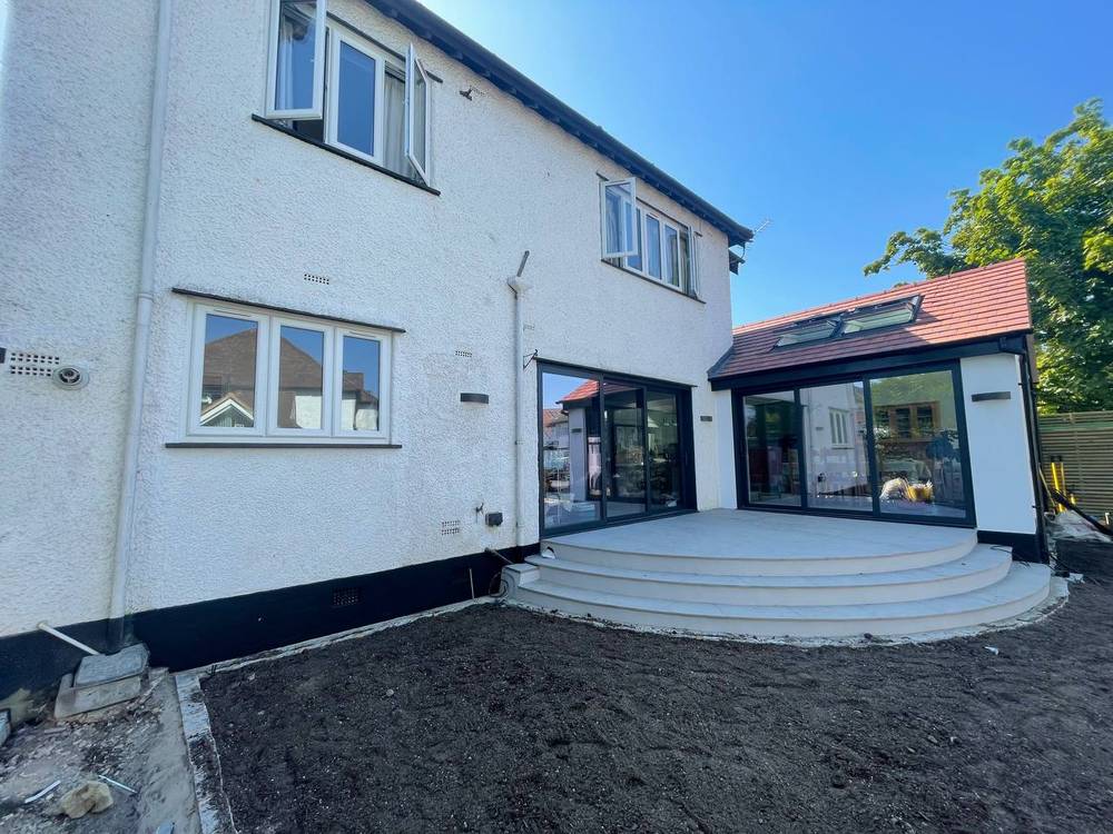 After — full rear elevation with new patio and steps