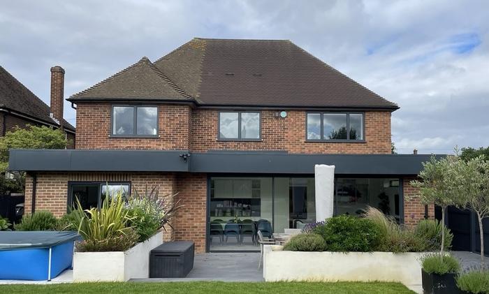 Rear elevation with two storey side extension, landscaped garden and full-width glazing