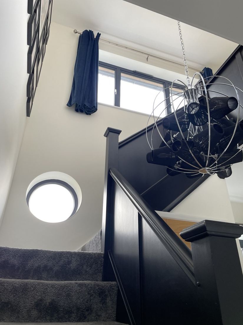 After — staircase with feature chandelier