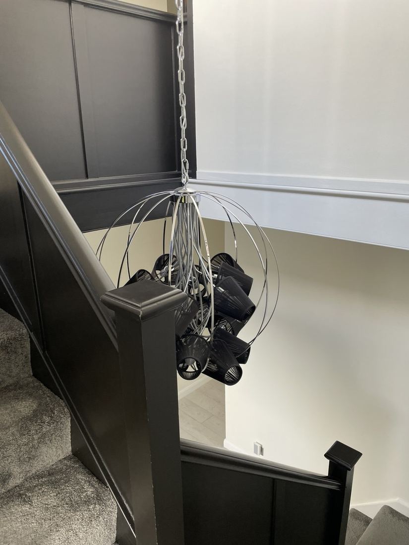 After — chandelier detail above the stairs