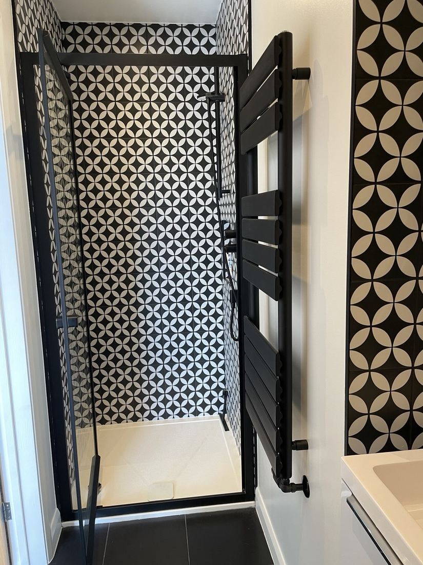 After — bathroom with patterned tiling and shower