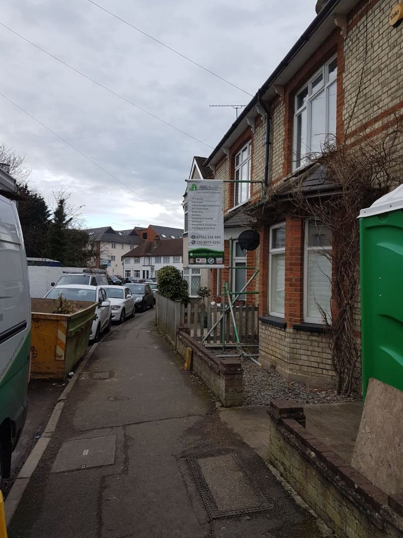 Before — street view with JMG Build site signage