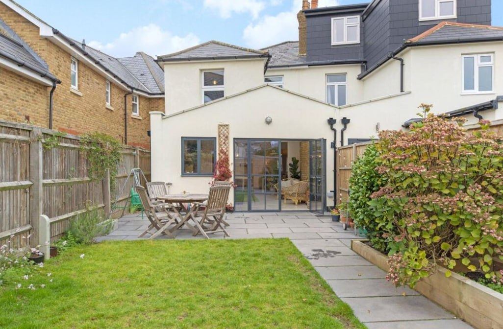 After — rear extension with render finish and landscaped garden