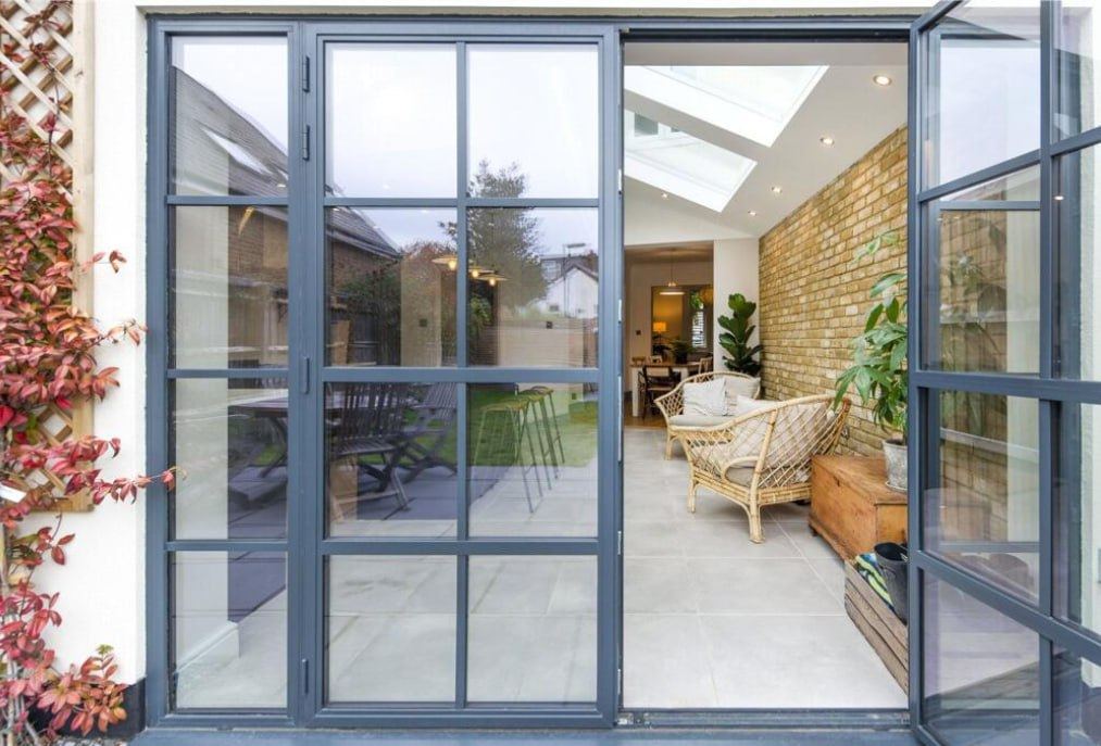 After — crittall style doors opening into rear extension