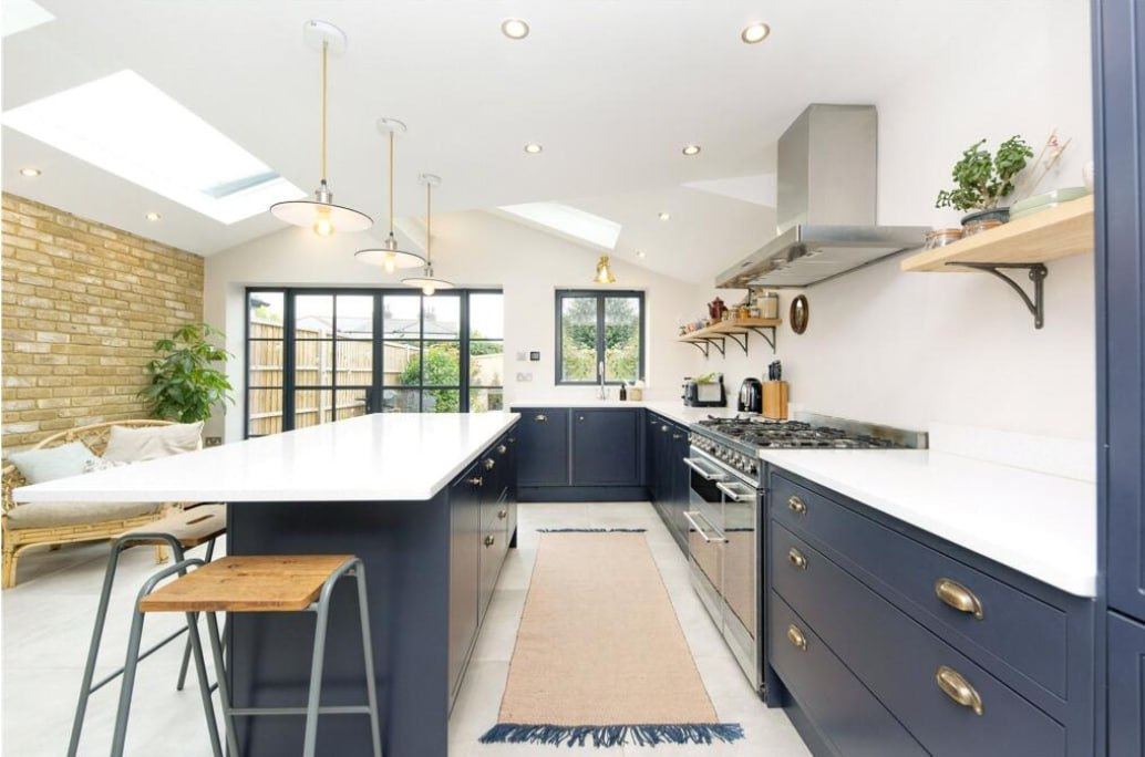 After — kitchen range cooker and exposed brick wall