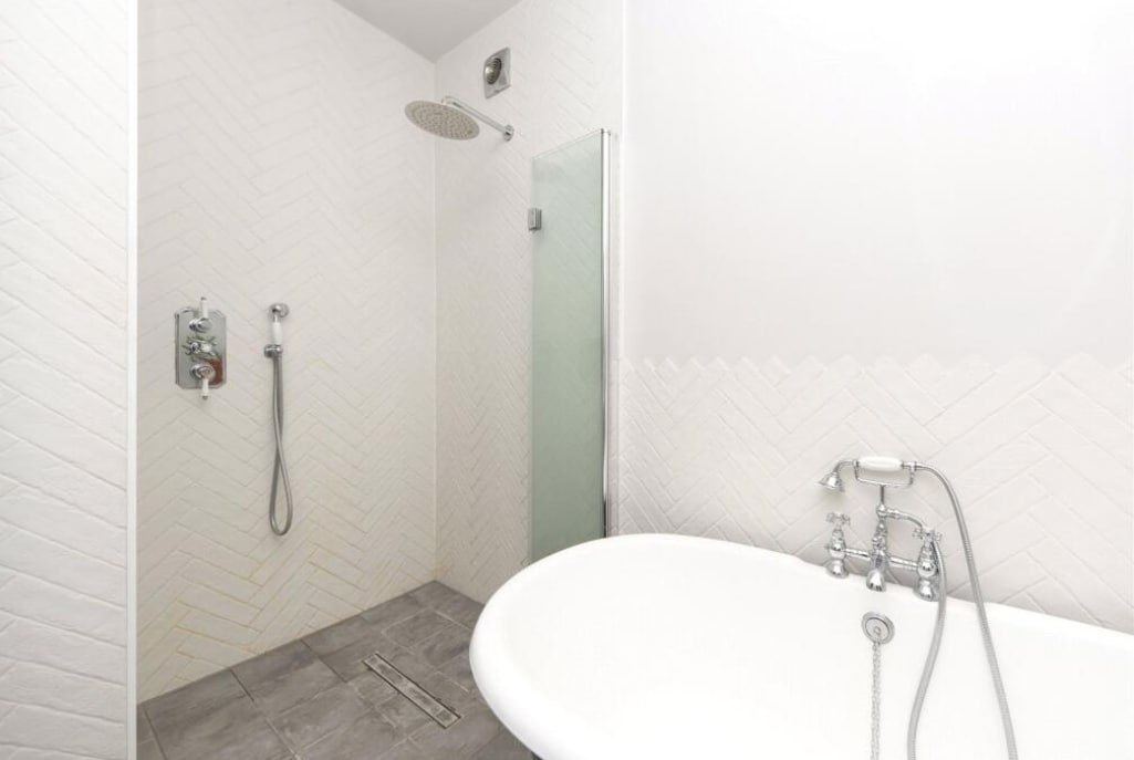 After — walk-in shower with herringbone tiling